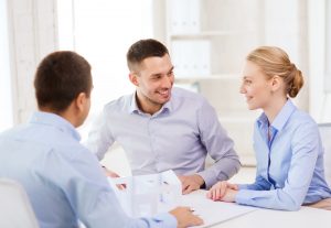 Three people talking in an office