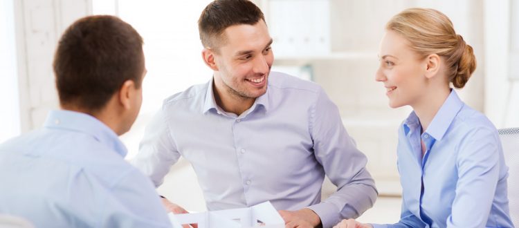 Three people talking in an office